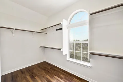 a view of a room with rack on the wall and a window