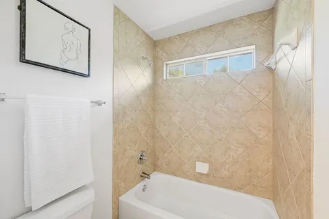 a bathroom with a bathtub and shower