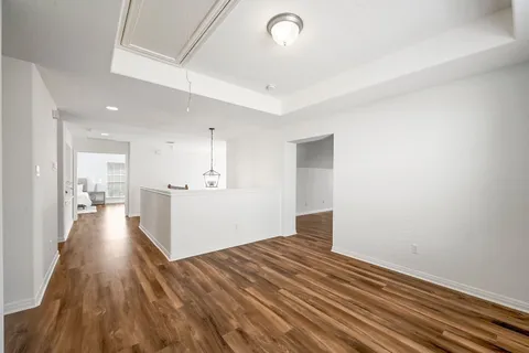 a view of a room with wooden floor