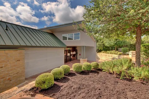 a front view of a house with garden