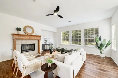 a living room with furniture and a fireplace