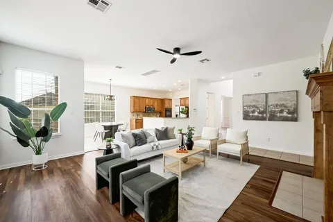 a living room with furniture and wooden floor