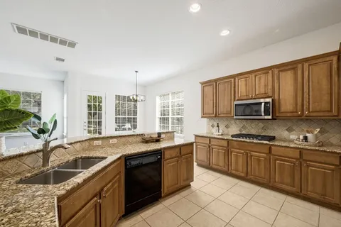 a kitchen with a sink stove and cabinets