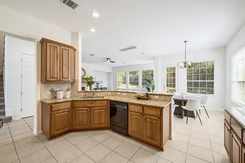 a kitchen with a sink and chairs