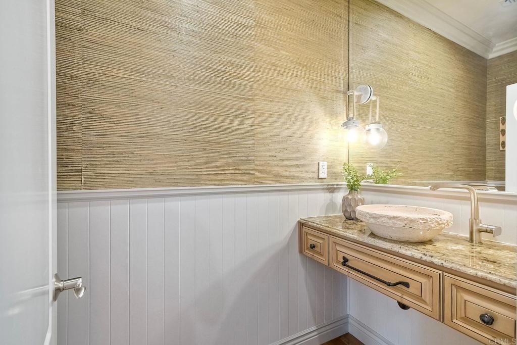 2559 Fire Mountain Drive Oceanside, CA 92054 - Photo 11 of 43 a bathroom with a granite countertop sink and a mirror