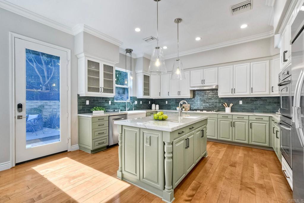 2559 Fire Mountain Drive Oceanside, CA 92054 - Photo 14 of 43 a kitchen that has a lot of white cabinets and stainless steel appliances