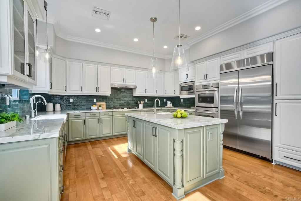 2559 Fire Mountain Drive Oceanside, CA 92054 - Photo 15 of 43 a kitchen with stainless steel appliances granite countertop a stove top oven a sink a refrigerator and white cabinets