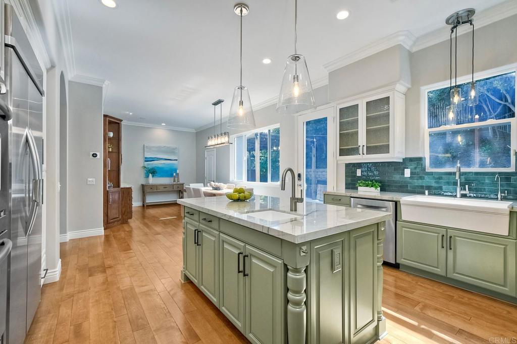 2559 Fire Mountain Drive Oceanside, CA 92054 - Photo 17 of 43 a kitchen with stainless steel appliances granite countertop a sink a stove and a wooden floors