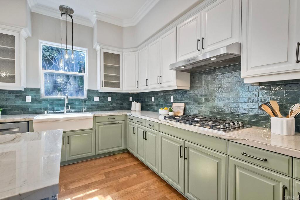 2559 Fire Mountain Drive Oceanside, CA 92054 - Photo 18 of 43 a kitchen with stainless steel appliances granite countertop a sink a stove and cabinets