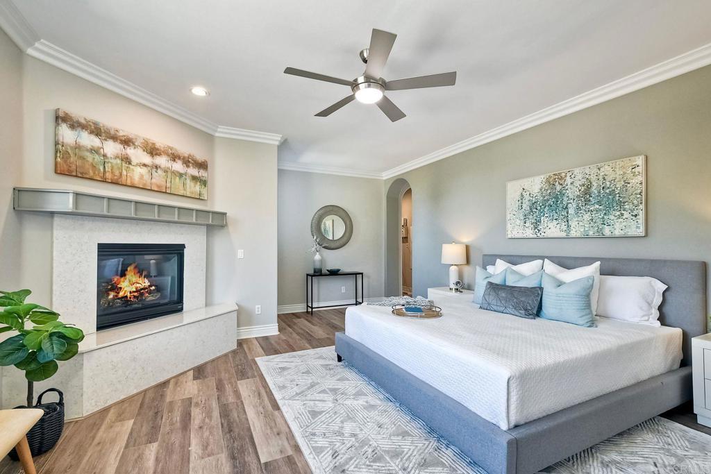 2559 Fire Mountain Drive Oceanside, CA 92054 - Photo 23 of 43 a bedroom with a large bed and a fireplace