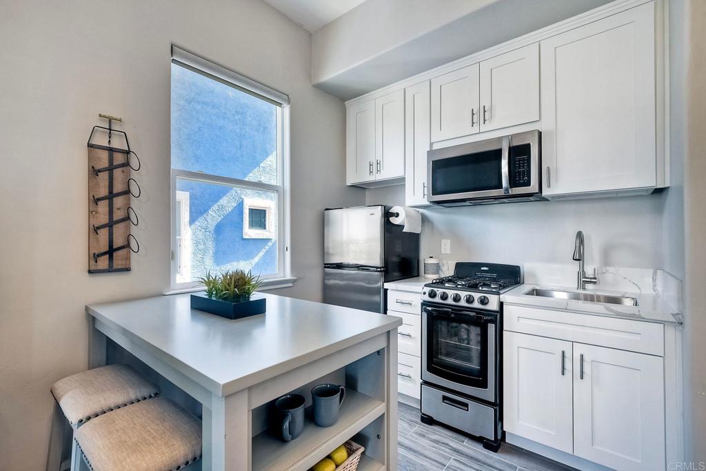 2559 Fire Mountain Drive Oceanside, CA 92054 - Photo 37 of 43 a kitchen with stainless steel appliances a white stove top oven and cabinets