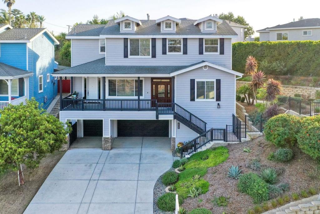 2559 Fire Mountain Drive Oceanside, CA 92054 - Photo 41 of 43 a front view of a house with garden