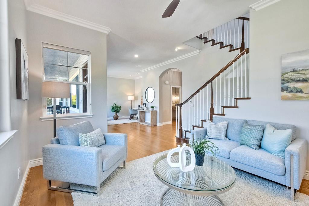 2559 Fire Mountain Drive Oceanside, CA 92054 - Photo 10 of 43 a living room with couches and a dining table with wooden floor