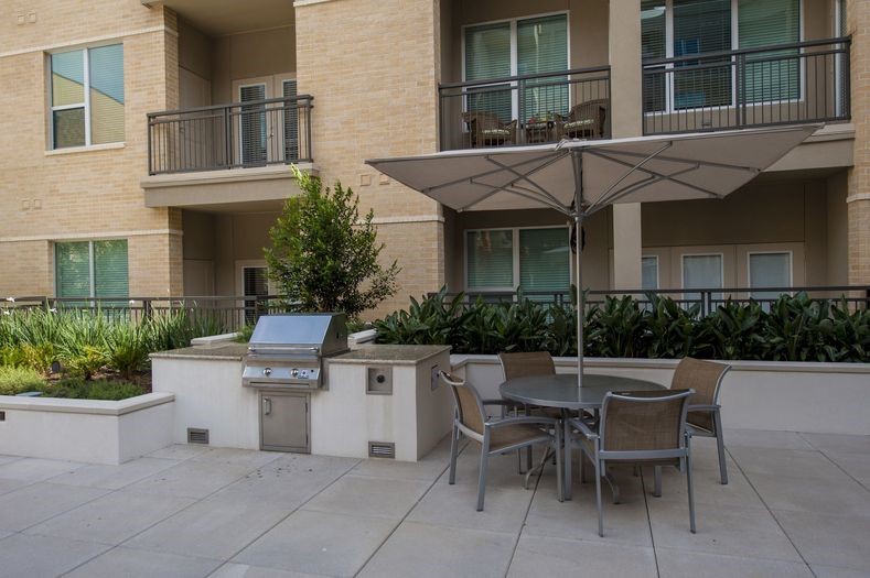 2111 Westheimer Road, Unit 1401 Houston, TX 77098 - Photo 9 of 16 a view of patio with a table and chairs and potted plants