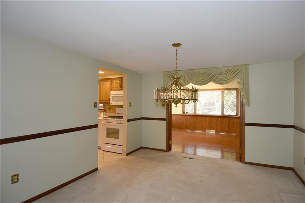 413 Thompson Run Road Pittsburgh, PA 15237 - Photo 11 of 25 a kitchen with stainless steel appliances granite countertop a refrigerator a stove a sink and a window
