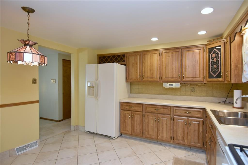 413 Thompson Run Road Pittsburgh, PA 15237 - Photo 13 of 25 a kitchen with a refrigerator a sink and cabinets