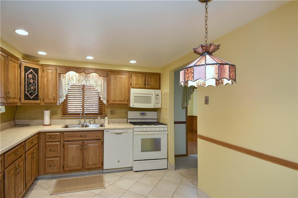 413 Thompson Run Road Pittsburgh, PA 15237 - Photo 14 of 25 a kitchen with a stove a sink and a refrigerator