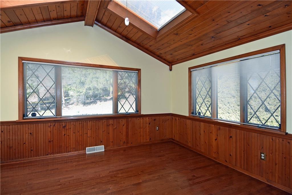 413 Thompson Run Road Pittsburgh, PA 15237 - Photo 15 of 25 a view of an empty room with wooden floor and a window