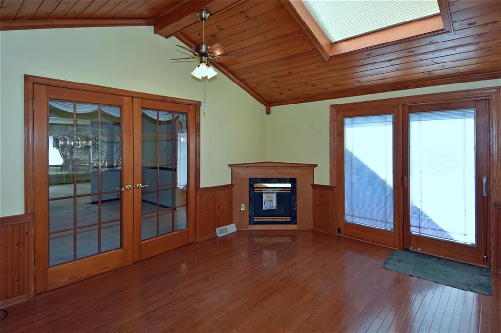 413 Thompson Run Road Pittsburgh, PA 15237 - Photo 16 of 25 an empty room with wooden floor and windows