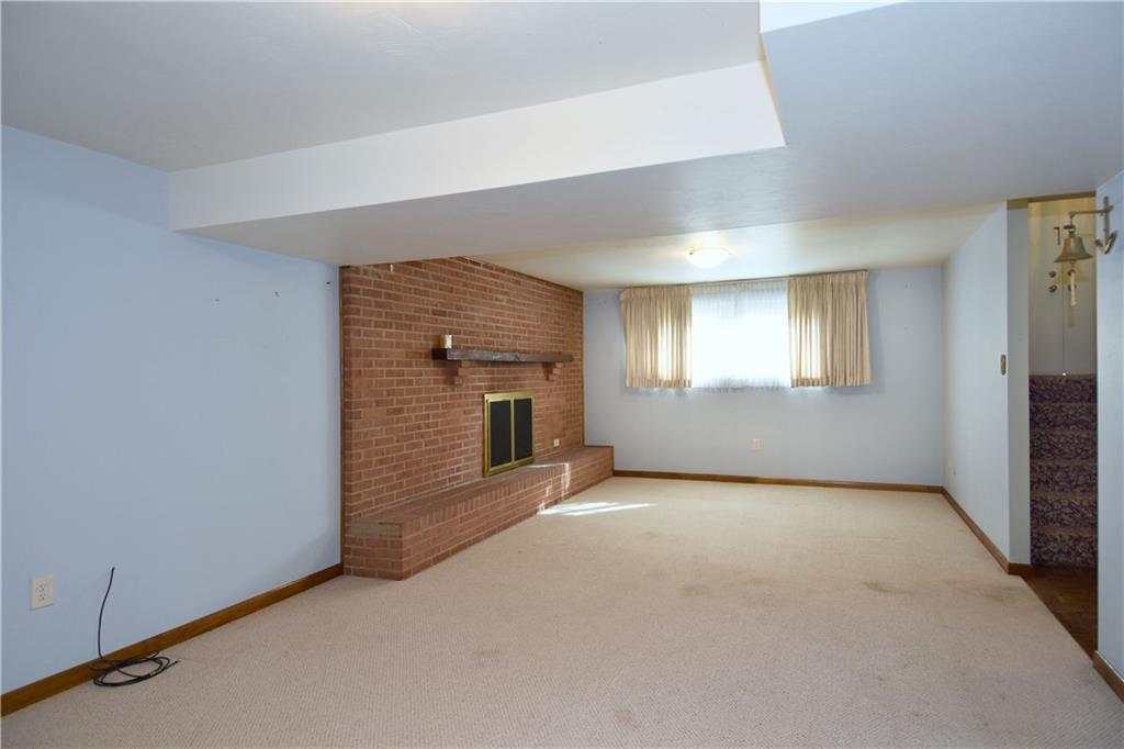 413 Thompson Run Road Pittsburgh, PA 15237 - Photo 23 of 25 a view of an empty room with a fireplace and a window