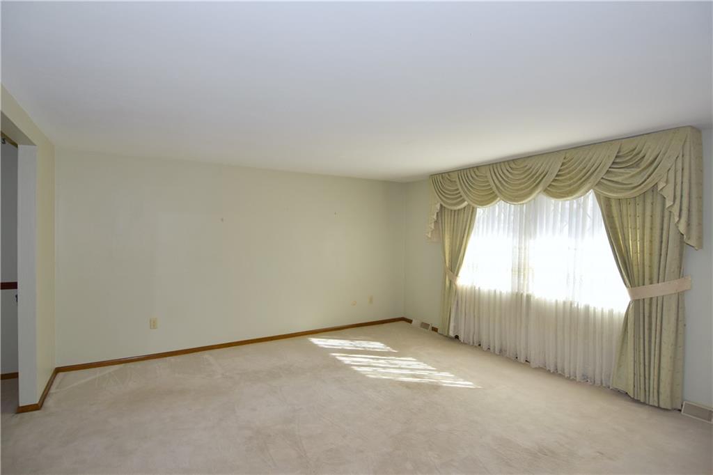 413 Thompson Run Road Pittsburgh, PA 15237 - Photo 8 of 25 an empty room with a chandeliers fan