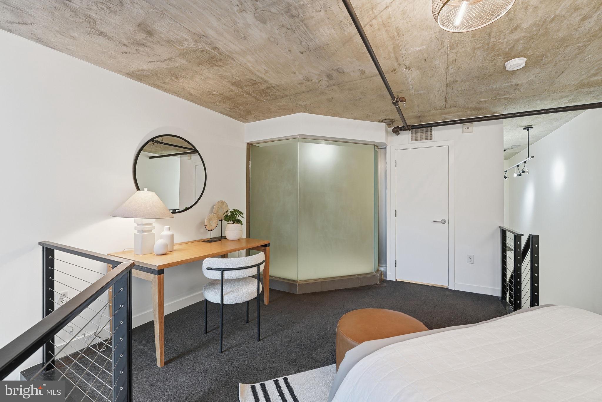 1515 15th Street Northwest, Unit 234 Washington, DC 20005 - Photo 15 of 33 a bedroom with a bed a desk and chair