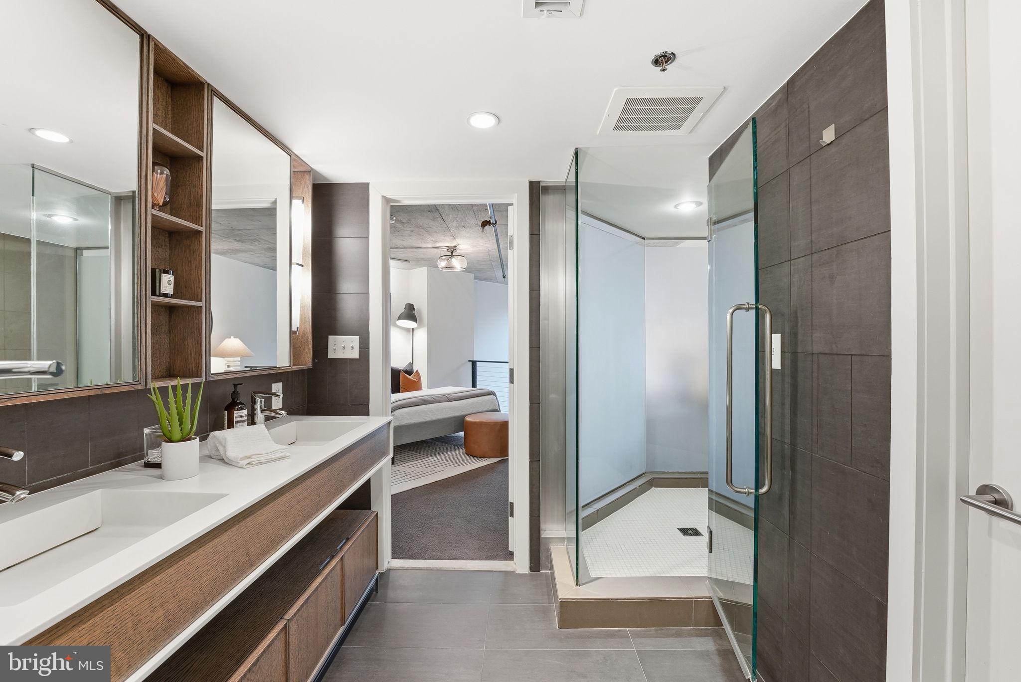 1515 15th Street Northwest, Unit 234 Washington, DC 20005 - Photo 17 of 33 a bathroom with a double vanity sink mirror and shower