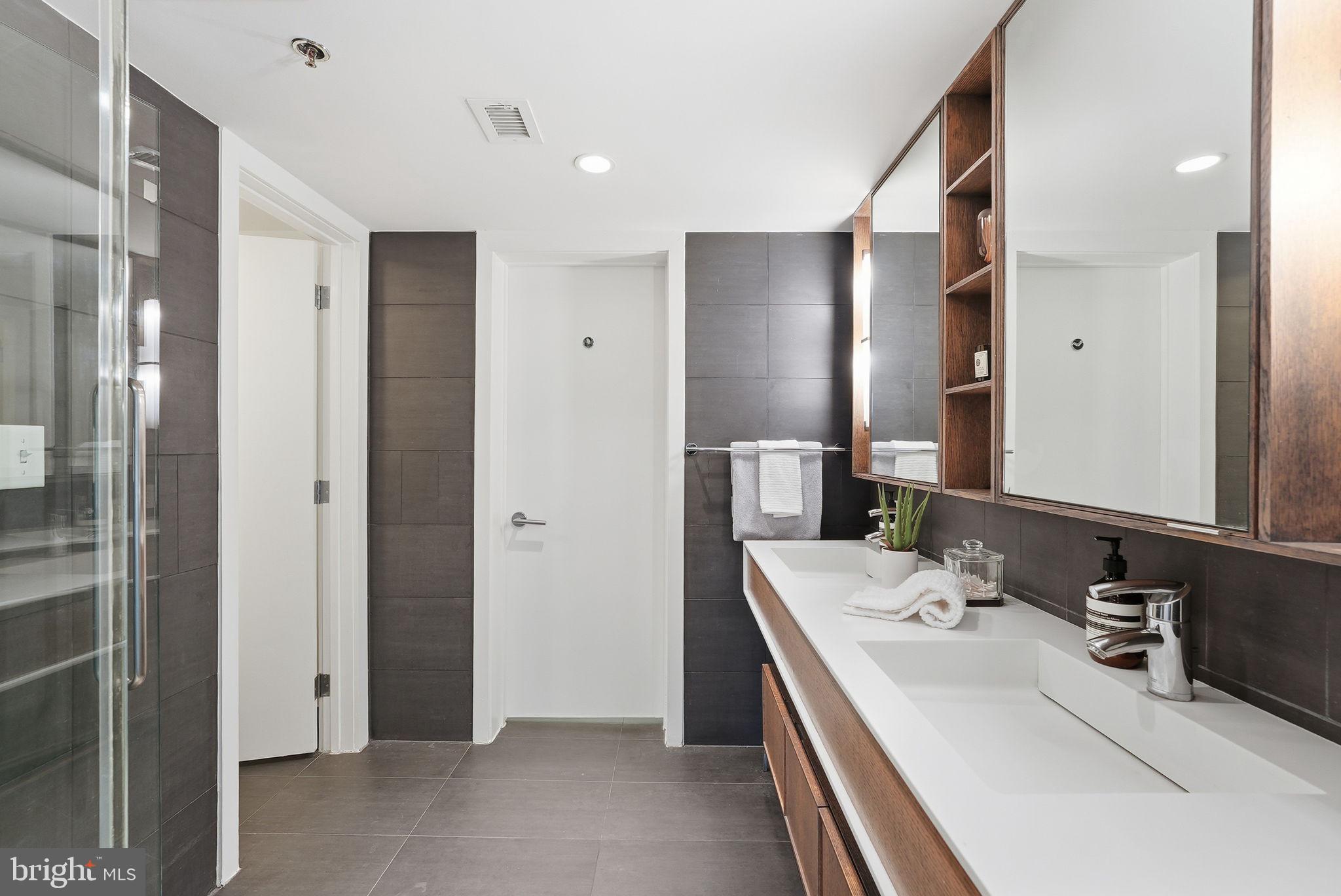 1515 15th Street Northwest, Unit 234 Washington, DC 20005 - Photo 19 of 33 a bathroom with a double vanity sink and mirror