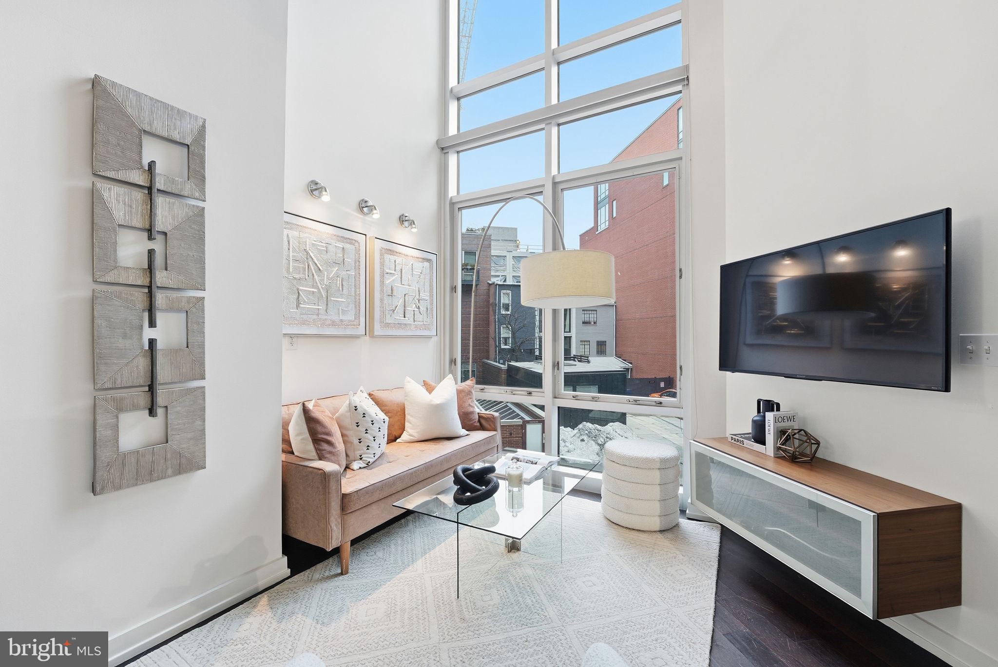 1515 15th Street Northwest, Unit 234 Washington, DC 20005 - Photo 5 of 33 a living room with furniture and a flat screen tv