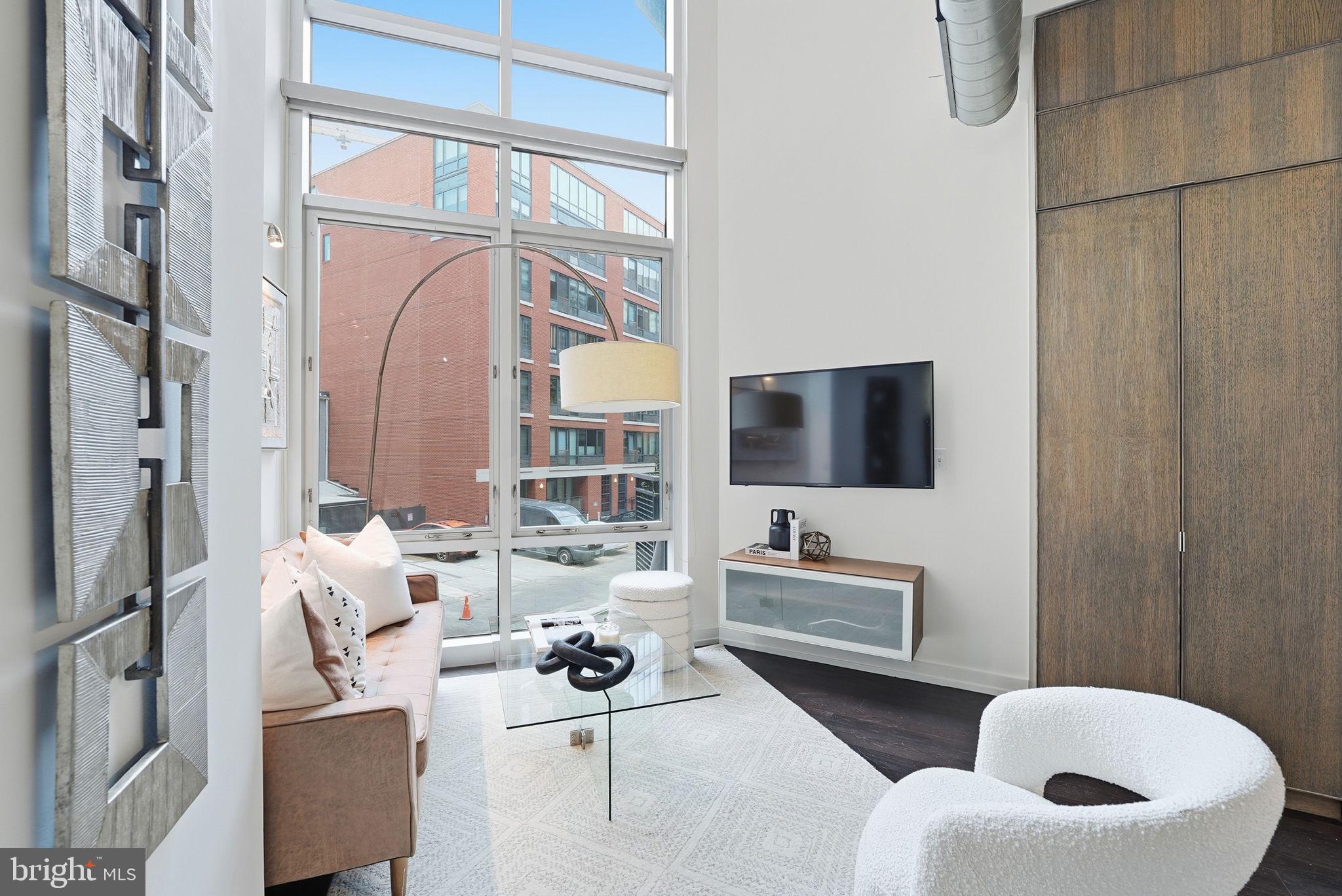1515 15th Street Northwest, Unit 234 Washington, DC 20005 - Photo 7 of 33 a living room with furniture and a floor to ceiling window