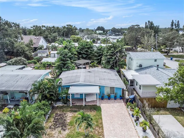 an aerial view of a house with a yard garage and lake view
