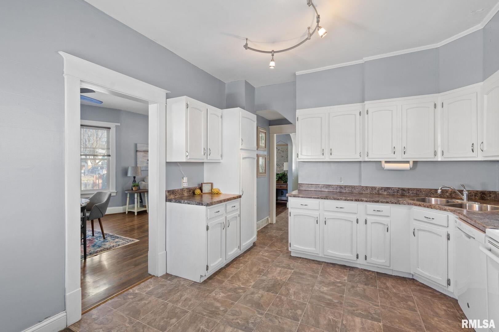 1602 37th Street Rock Island, IL 61201 - Photo 11 of 37 a kitchen with granite countertop a white stove top oven and white cabinets