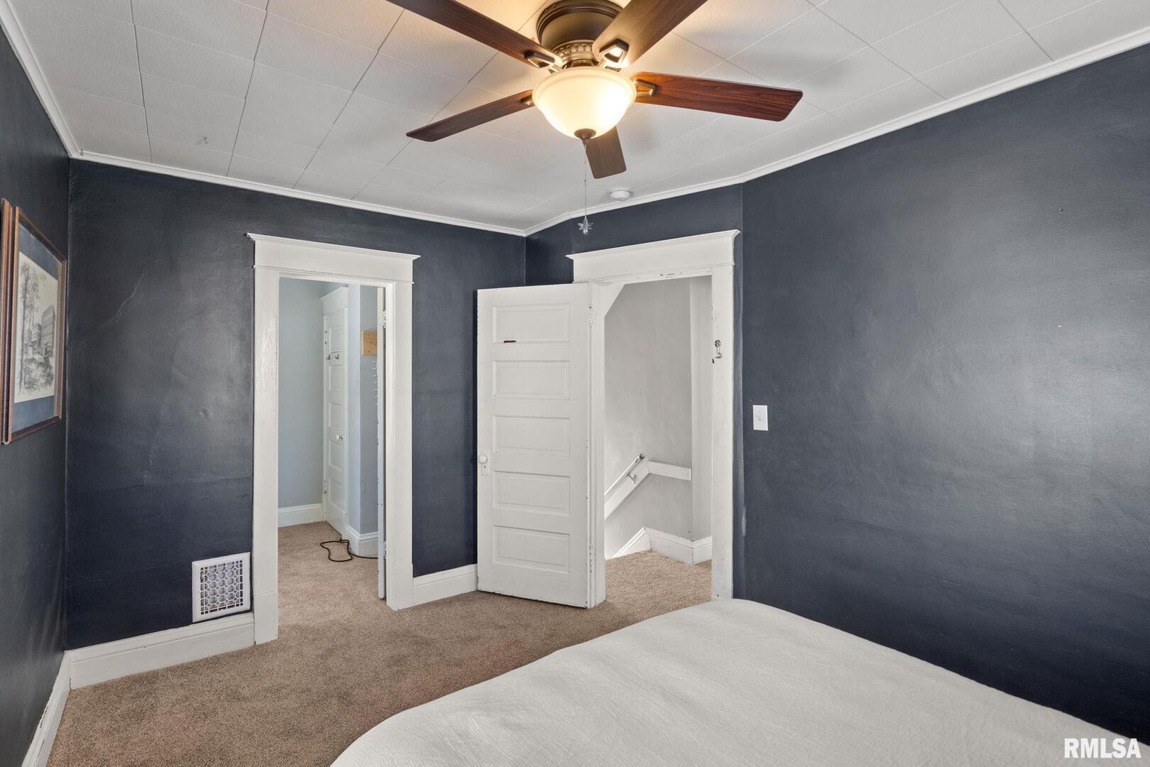 1602 37th Street Rock Island, IL 61201 - Photo 14 of 37 a bedroom with a bed and a chandelier fan