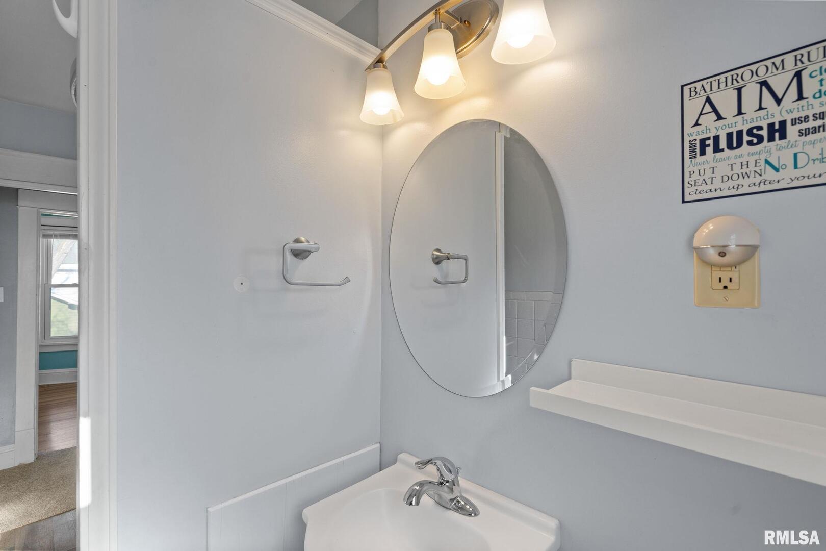 1602 37th Street Rock Island, IL 61201 - Photo 19 of 37 a bathroom with a sink a mirror and a shower