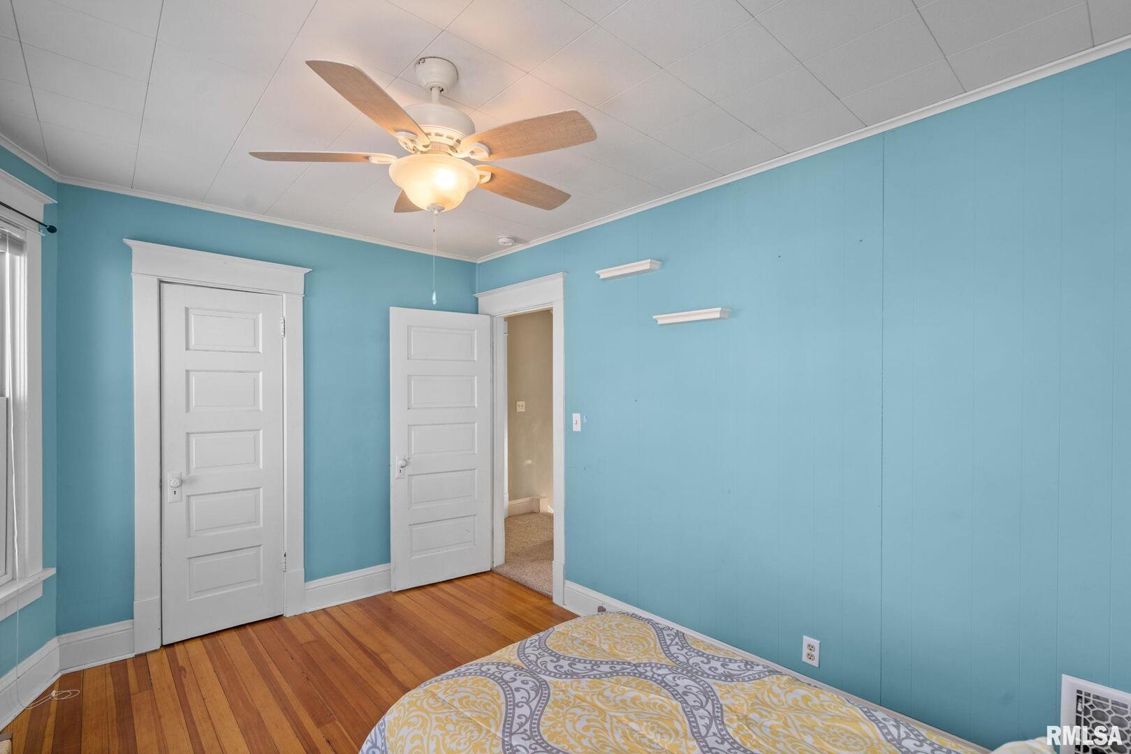 1602 37th Street Rock Island, IL 61201 - Photo 21 of 37 a bedroom with a bed and a chandelier