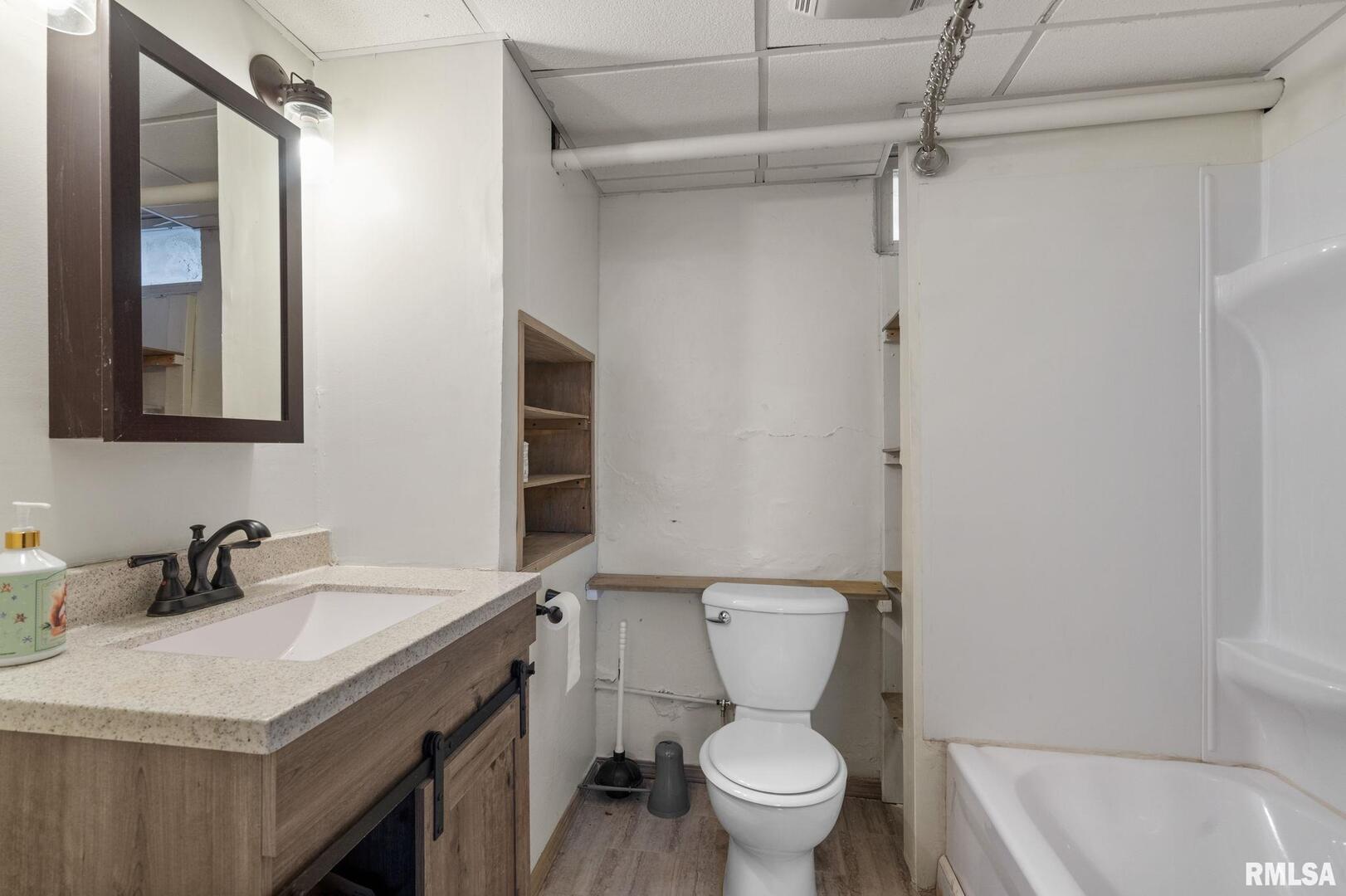1602 37th Street Rock Island, IL 61201 - Photo 23 of 37 a bathroom with a sink toilet vanity and shower