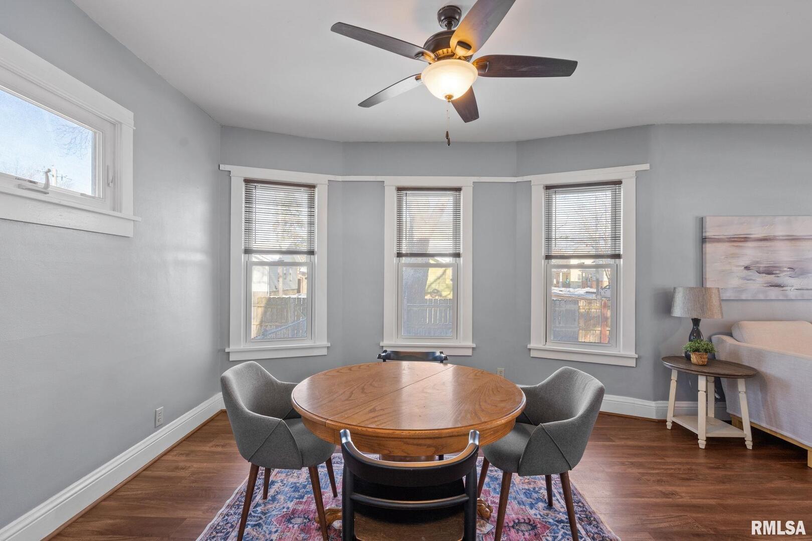 1602 37th Street Rock Island, IL 61201 - Photo 8 of 37 a view of a dining room with furniture window and wooden floor