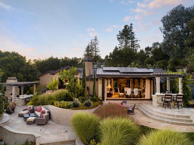 a view of a swimming pool with a patio and a garden