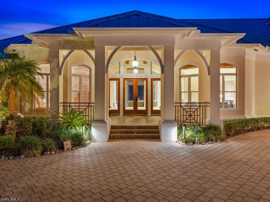 7051 Hunters Road Naples, FL 34109 - Photo 1 of 49 a front view of a house with a yard