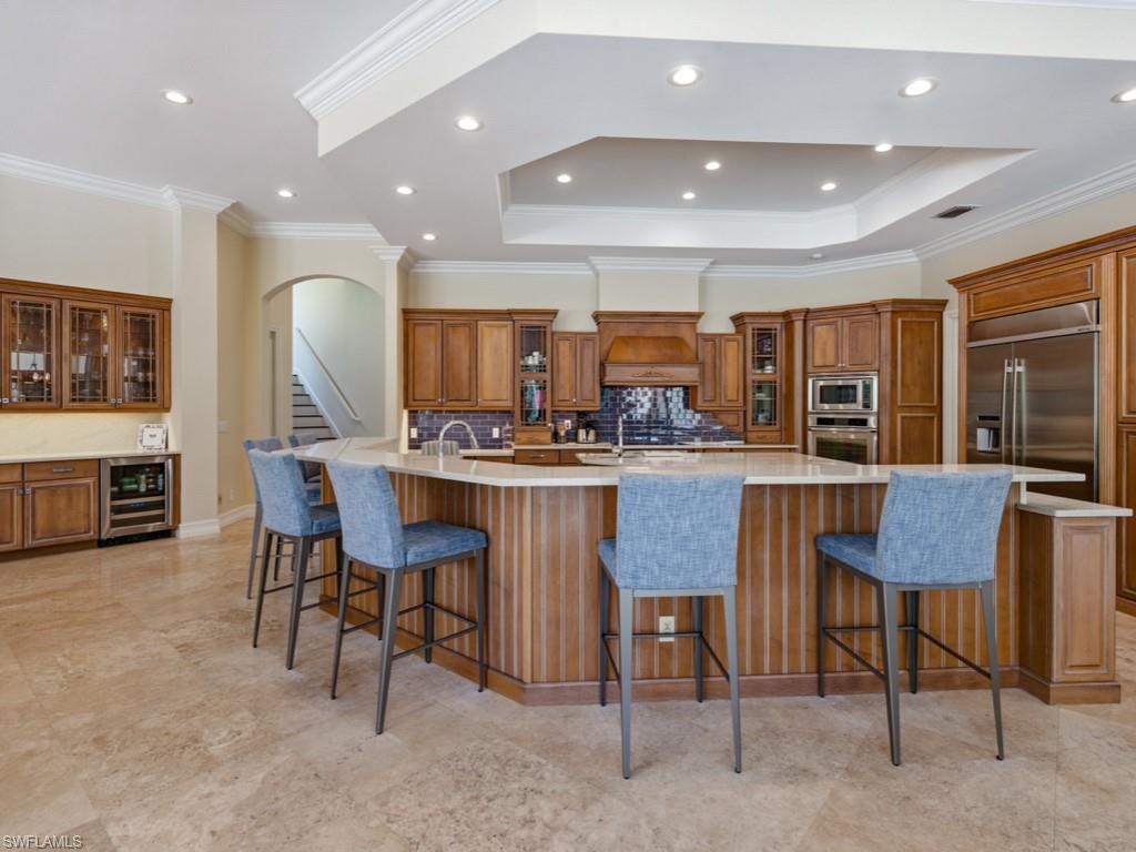 7051 Hunters Road Naples, FL 34109 - Photo 12 of 49 a kitchen with a table and chairs in it