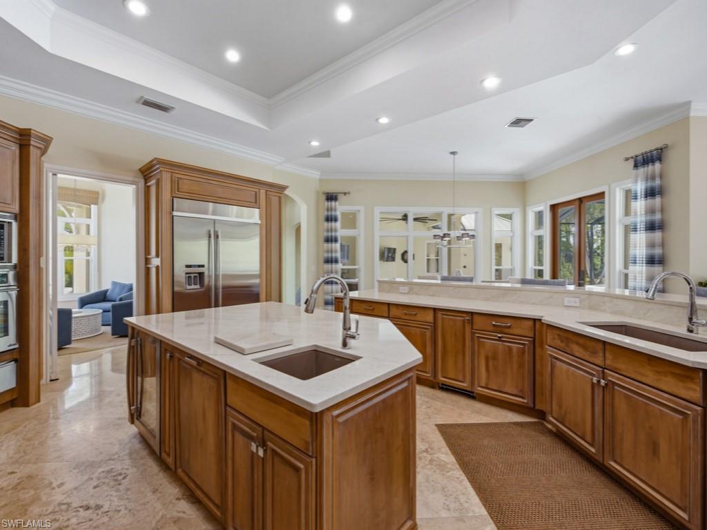 7051 Hunters Road Naples, FL 34109 - Photo 14 of 49 a kitchen with sink stove and refrigerator