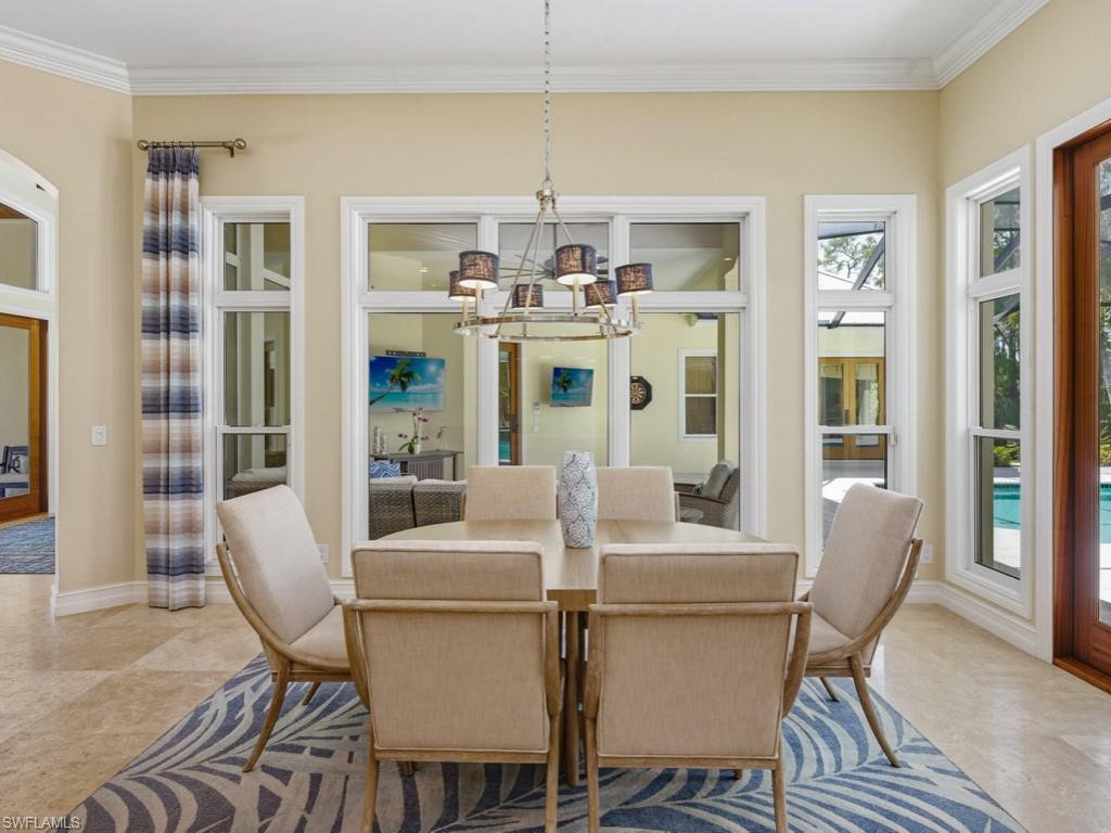 7051 Hunters Road Naples, FL 34109 - Photo 16 of 49 a view of a dining room with furniture window and wooden floor