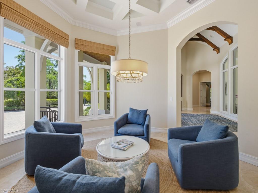 7051 Hunters Road Naples, FL 34109 - Photo 17 of 49 a living room with furniture and a large window