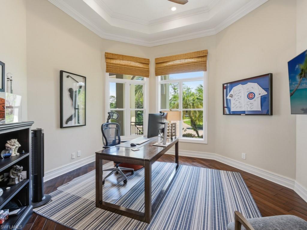 7051 Hunters Road Naples, FL 34109 - Photo 18 of 49 a living room with furniture and a wooden floor
