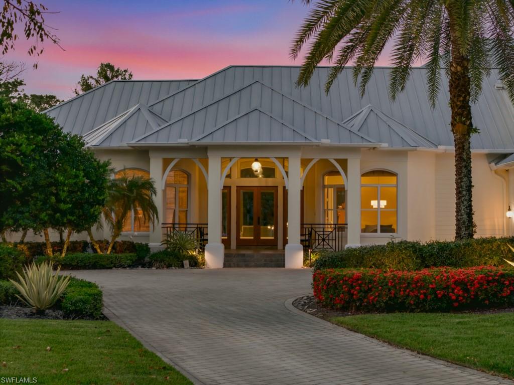 7051 Hunters Road Naples, FL 34109 - Photo 2 of 49 a view of a building with a yard
