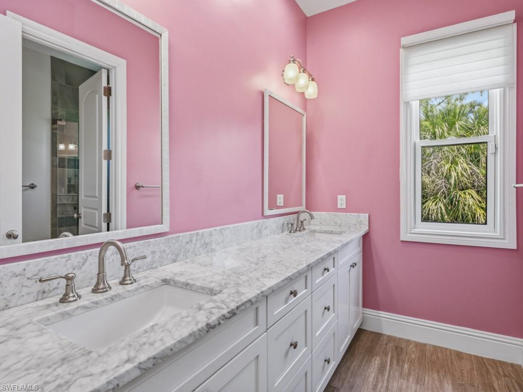 7051 Hunters Road Naples, FL 34109 - Photo 28 of 49 a bathroom with a granite countertop sink and a mirror
