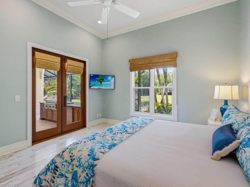 7051 Hunters Road Naples, FL 34109 - Photo 31 of 49 a bedroom with a bed and a dresser next to a window