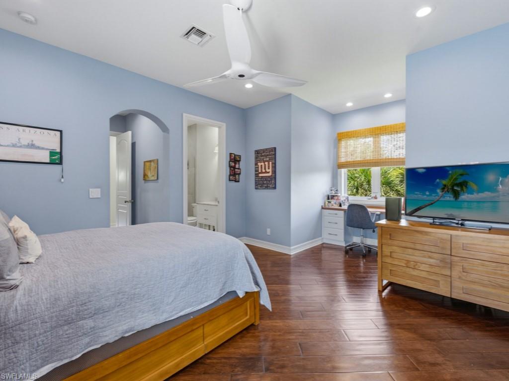 7051 Hunters Road Naples, FL 34109 - Photo 33 of 49 a bedroom with a bed and a couch