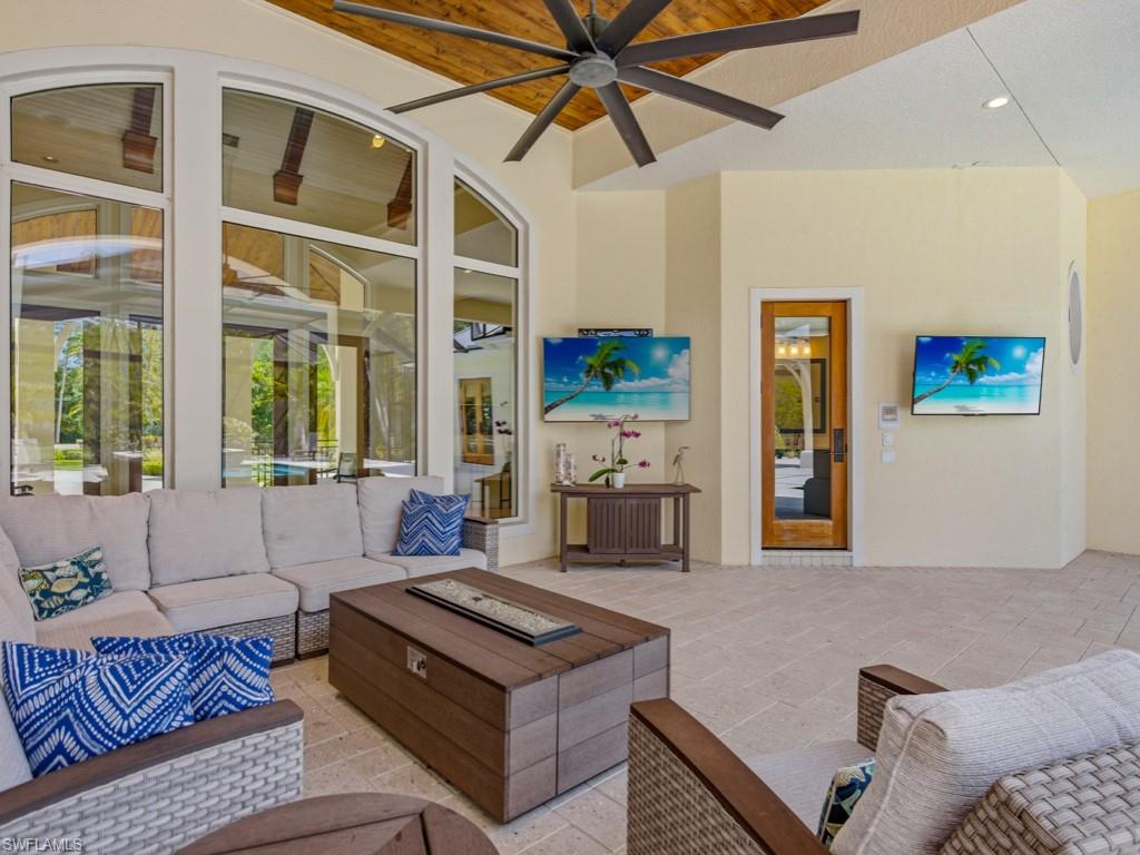 7051 Hunters Road Naples, FL 34109 - Photo 35 of 49 a living room with furniture and a large window