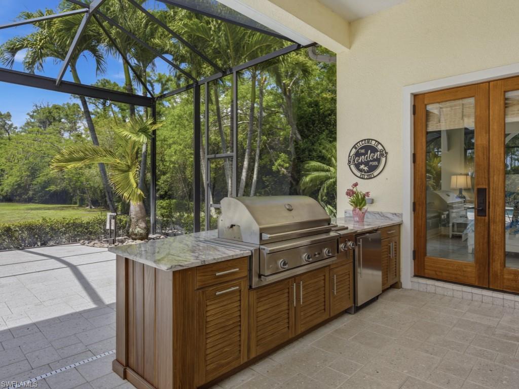 7051 Hunters Road Naples, FL 34109 - Photo 37 of 49 a kitchen with a stove and a microwave oven